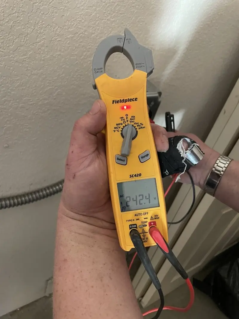 Voltage testing with clamp meter during Outlet Installation in Princeton